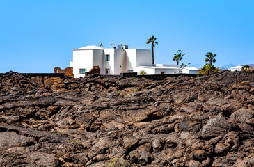White villa in the black volcanic landscape, Island Lanzarote, Canary Islands, Spain, Europe.
