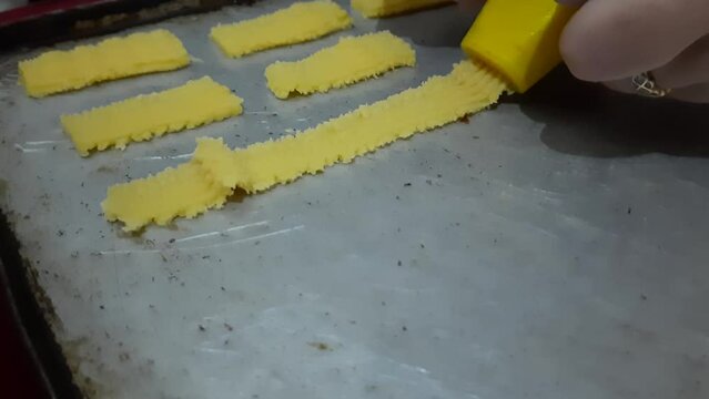 Making Semprit cakes or butter cakes, one of the special Eid pastries in Indonesia