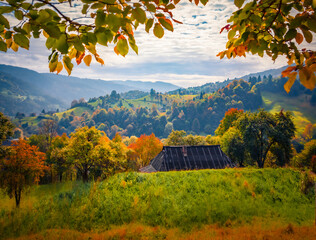 Old wooden shalet on the mountain meadow. Gloomy autumn view of Carpathian mountains, Ukraine, Europe. Beauty of countryside concept background. - 786869218