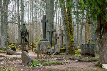 An ancient cemetery with large massive ancient grave crosses.