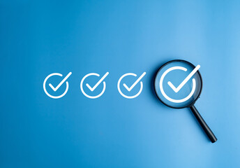 Magnifier enlarging the correct or check mark on blue background. Business industrial quality control and voting concept. Approval and Contract assignment theme.