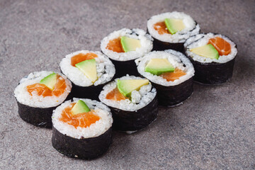 delicious fresh futomaki sushi roll with salmon and avocado
