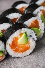 delicious fresh futomaki sushi roll with salmon and avocado