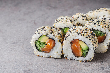 delicious fresh sushi roll with salmon cucumber and avocado