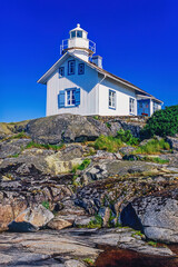 Idyllic old wooden lighthouse on a rocky island in Sweden