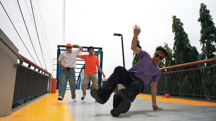 Panorama shot of hipster wearing stylish cloth and doing freeze pose. Group of professional dancer...