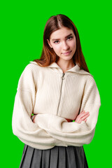 Young Woman Posing in Stylish Crop Hoodie and Pleated Skirt Against Green Screen