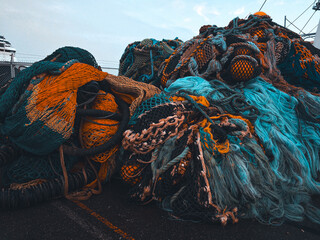 Tangled textures of fishing nets in a medley of oceanic hues