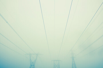 Power lines and towers in the fog