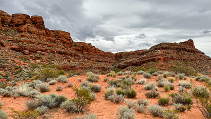 Hiking among the red rocks on an overcast day