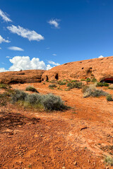 Bright blue skies against red rock hiking trail
