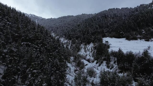 Aerial view of a snowy valley with a river in Spain