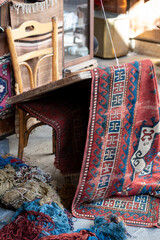 Antique carpet and stretcher with wool yarn at restoration workshop