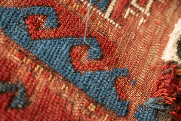 Closeup detail of border pattern threadbare carpet restoration
