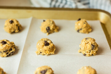 Oatmeal cookie dough scoops on baking sheet