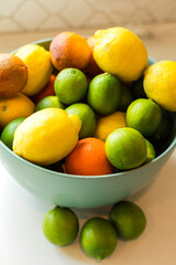 Assorted citrus fruits in a green bowl