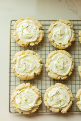 Frosted lime sugar cookies on a cooking rack
