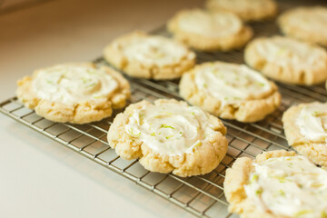 Frosted lime cookies cooling on a wire rack