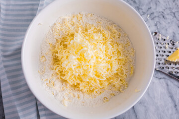 Bowl of cold, grated butter ready for mixing