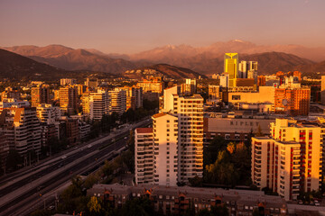 Beautiful sunset view to city buildings and Andes chain of mountains