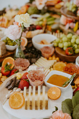 Fototapeta na wymiar Close up of Colorful Charcuterie Table with Fruits and Meats