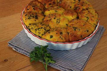 Turmeric curcuma and parsley bread . Healthy turmeric Bread in a cake pan on a gray striped napkin...