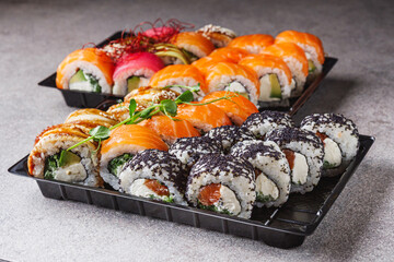set of delicious fresh sushi roll with salmon avocado cucumber tuna eel Philadelphia cheese