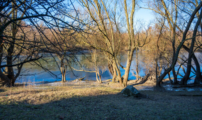 Frozen lake in the autumn forest.