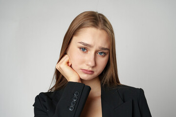 Young woman standing upset and distressed against gray background
