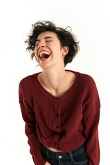 A woman laughing heartily against a white background, embodying genuine happiness and positivity