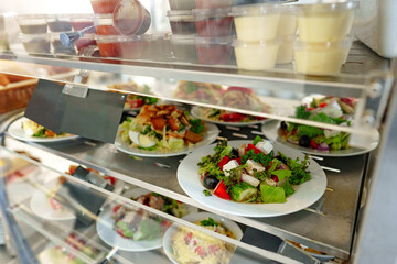 Freshly Prepared Salads on Display in a Cafeteria During Lunchtime