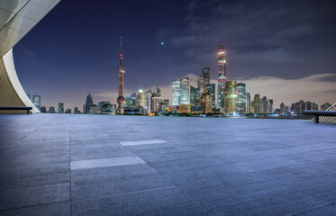 Empty square floor and modern city building scenery at night in Shanghai