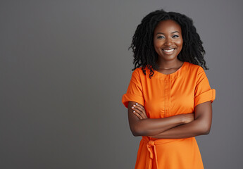 Engaging Smile from Woman in Orange with Confident Arms Crossed Stance - 786905004