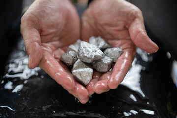 The wet man's hand was holding silver, or platinum, or rare earth minerals