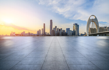 Empty square floor with modern city buildings at sunset in Guangzhou