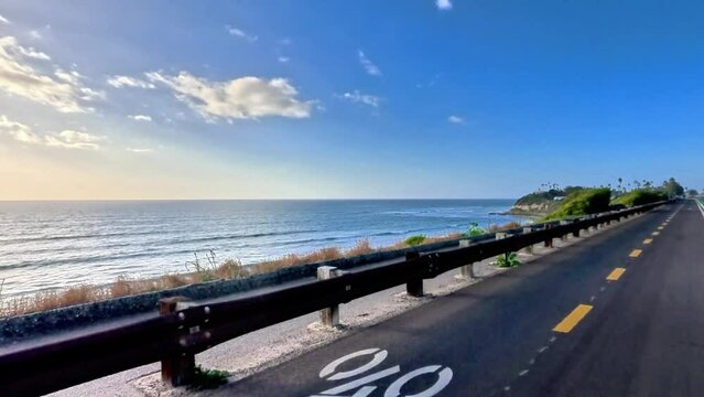 Immersive point of view footage of a cyclist pedaling along the a bike path parallel to the Pacific Coast Highway 101 near Escondido, California