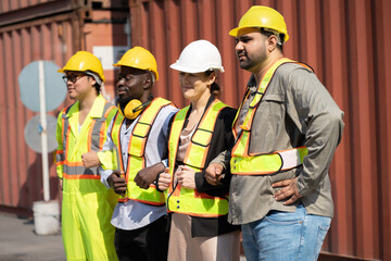 Asia, African, caucasian team logistic engineer worker or foreman cross arm at container site	