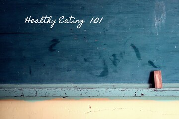 Green vintage school chalkboard background with handwritten chalk text : Healthy Eating 101