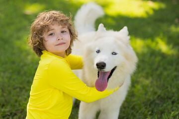 Portrait of Child and dog. Boy Playing with Husky. Kid hugging dog in the park. Kid hugs a dog in the park. Pets and Childhood. Kids Life style with dogs. Kid plays with a husky dog. - 786929422