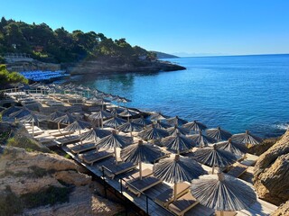 Beach with umbrellas and chairs in Montenegro, Adriatic sea.