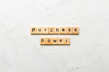 Purchase power word written on wood block. Purchase power text on cement table for your desing,...