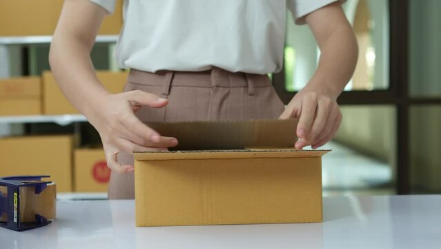 Online small business owners are packing their ordered products into the boxes for their customers based on the concept of online shopping - online shopping.
