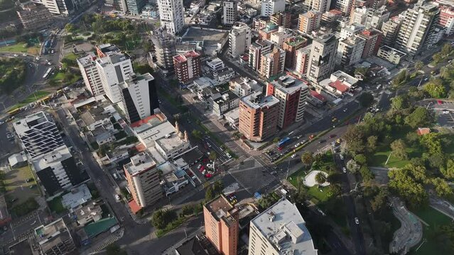 Aerial drone video view footage of Qutio early morning sunrise capital city of Ecuador La Carolina Park traffic Catedral Metropolitana de Quito south american skyline