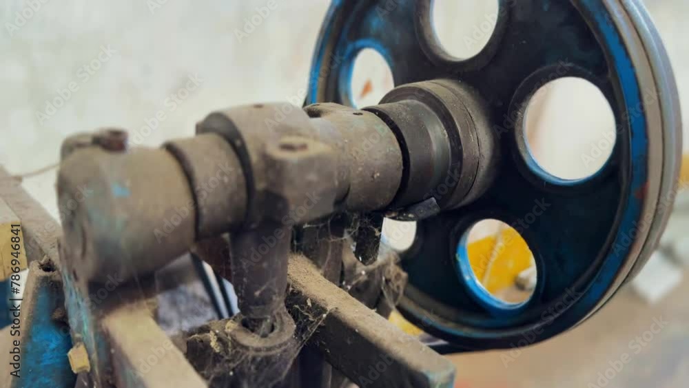 Poster old machine with wheels. the old machine is dusty and has cobwebs
