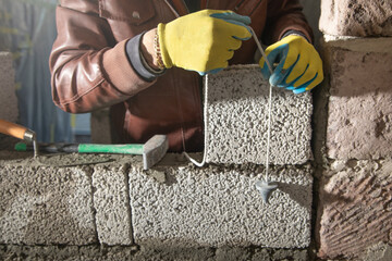 Worker measure concrete wall on old measure tool.