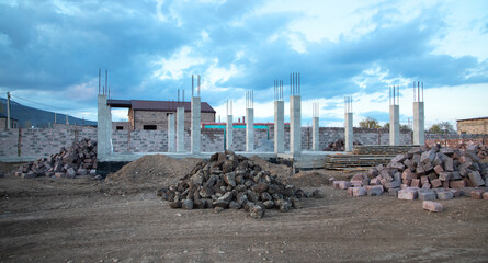 New unfinished house construction in a construction site.