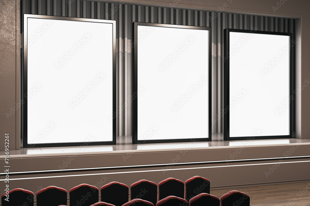 Poster triple blank screen setup in a modern cinema hall with red seating. 3d rendering