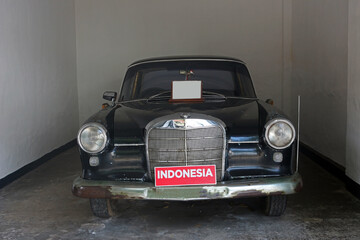 A classic black car in the garage