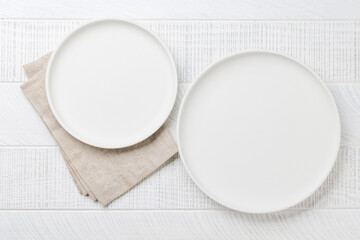 Empty plates on wooden table, overhead view
