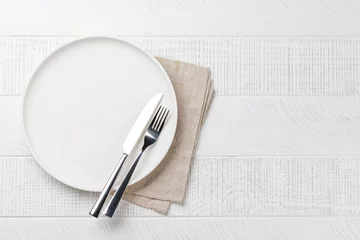 Outdoor kussens Empty plate on wooden table, overhead view © karandaev